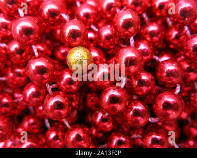 Yellow bead among red ones. (Concept diversity, difference, loneliness). Stock Photo