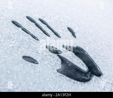 Handprint on the icy window Stock Photo
