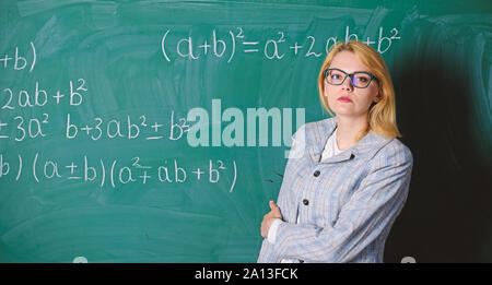 woman in classroom. teacher on school lesson at blackboard. Back to school. Teachers day. Study and education. Modern school. Knowledge day. Confident in their successful future. serious woman. Stock Photo