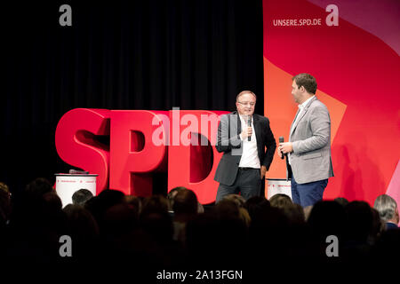 Ettlingen, Germany. 23rd Sep, 2019. Andreas Stoch (l), the SPD state chairman of Baden-Württemberg and the SPD general secretary Lars Klingbeil speak during a regional conference. At regional conferences, the SPD presents its candidates for election to the party presidency. Duos of a woman and a man are the main candidates for party chairmanship. The new SPD leadership will be determined during a survey of members in October, and the results will be known on October 26. Credit: Philipp von Ditfurth/dpa/Alamy Live News Stock Photo