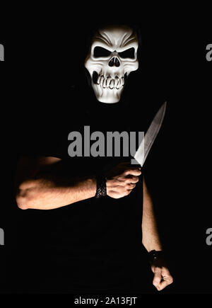 Man with scary mask and knife in halloween Stock Photo