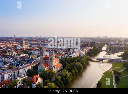 City view with Maximilianskirche and Reichenbach bridge over Isar at sunrise, Isarvorstadt, aerial view, Munich, Upper Bavaria, Bavaria, Germany Stock Photo