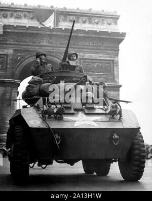 World War II American M-8 light armored car, rolling past the Arc de Triomphe in Paris. Stock Photo