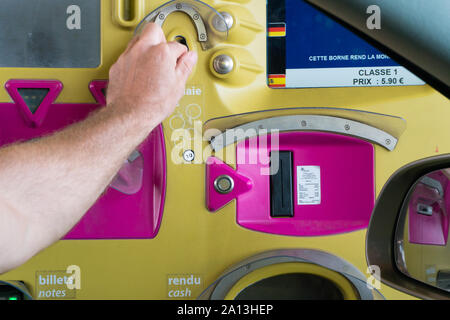 Rouen, Seine-Maritimne / France - 12 August 2019: man paying toll at an automatic toll booth station on a French highway close up view Stock Photo
