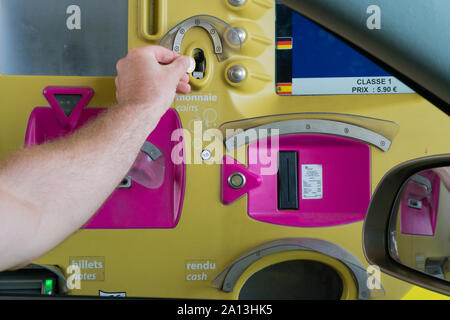 Rouen, Seine-Maritimne / France - 12 August 2019: man paying toll at an automatic toll booth station on a French highway close up view Stock Photo