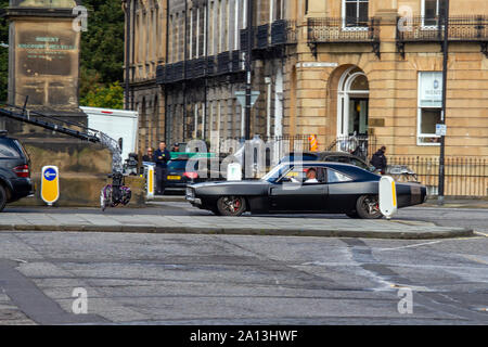 Vin Diesel's stand-in drives his car down the street during the filming. Fast & Furious 9 has wrapped production in Edinburgh, after several weeks of filming for the latest movie in the high-octane car chase franchise. The last remaining scenes were shot today on Melville Street, a pretty Georgian terrace in the capital's West End. Stunt drivers, standing in for stars such as Vin Diesel, drove their muscle cars up and down the street, alongside camera vehicles. Fast & Furious 9 is due for release on 22 May 2020.