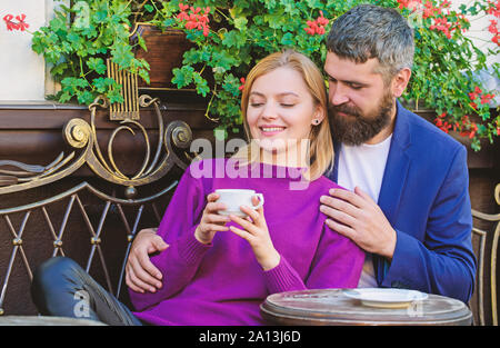 Travel and vacation. Explore cafe and public places. Couple cuddling cafe terrace. Couple in love sit cafe terrace enjoy coffee. Pleasant family weekend. Married lovely couple relaxing together. Stock Photo