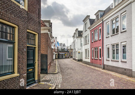 Muiden,The Netherlands, August 21, 2019: street in the old town center with brick houses, some of them painted white or red Stock Photo