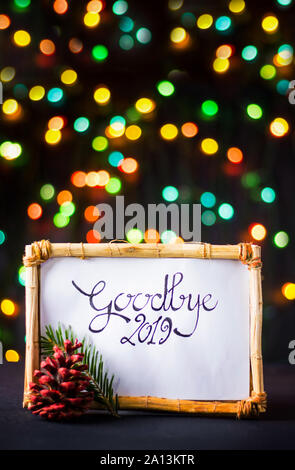 Goodbye 2019 New Year note with colorful festive background Stock Photo