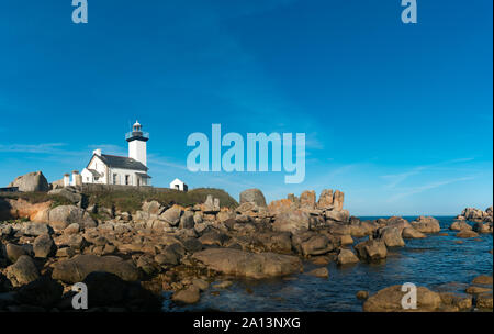 View of the picturesque white Pontusval lighthouse and bay on the north coast of Brittany in France Stock Photo