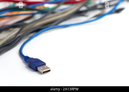 Data transfer computer connector with tangled cables on white background. Tech support, network infrastructure concept. Stock Photo