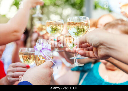 Cheers. Group of people drinking and toasting in restaurant. Hands holding glasses of champagne and wine making toast. Christmas new year wedding holiday party time. Celebration and nightlife concept Stock Photo