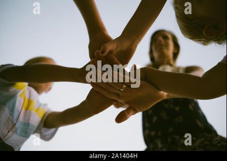 Group of kids stacking hands together Stock Photo - Alamy