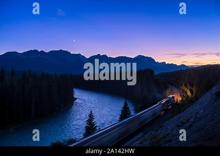 Conjunction of the waxing crescent moon near Venus above Banff National Park, Canada. Stock Photo