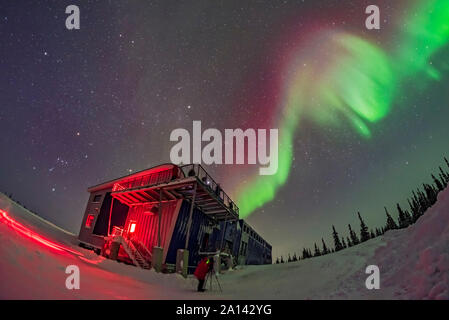 Orion and an aurora swirl over Churchill Northenr Studies Centre, Manitoba, Canada. Stock Photo