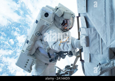 Astronaut in outer space is shooting the Earth. Elements of this image were furnished by NASA Stock Photo