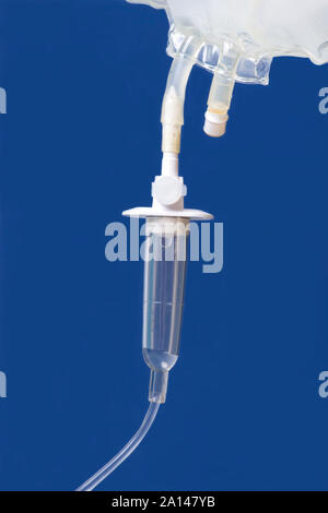 IV Bag and drip chamber on blue background. Stock Photo