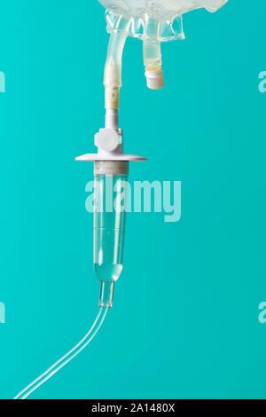 IV Bag and drip chamber on aqua background. Stock Photo