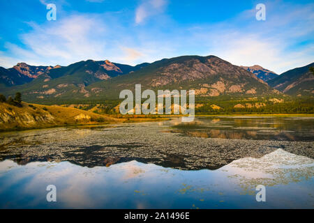Mountains reflected in the Columbia Wetlands in Fall or Autumn, near Invermere, British Columbia, Canada Stock Photo