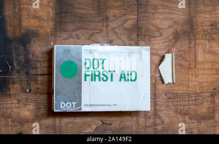 A workplace factory has an important first aid kit hanging on the wall, just in case there is a small medical emergency Stock Photo