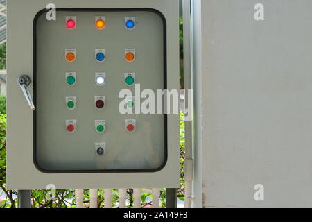 Closeup control panel lamps behind the blurred glass cover of switchboard, focus on white lamp with the word low, also can see reflection of photograp Stock Photo