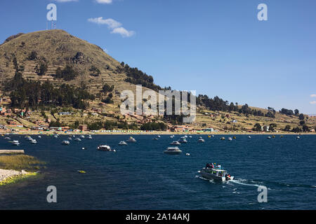 COPACABANA, BOLIVIA - OCTOBER 17, 2014: Tour boat entering the bay of Copacabana on the shore of Lake Titicaca in Bolivia Stock Photo
