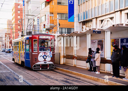 DEC 2, 2018 Hakodate, JAPAN - Hakodate city tram vintage streetcar approaching station near JR train station. The Tram well-established network throug Stock Photo