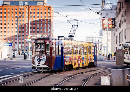 DEC 2, 2018 Hakodate, JAPAN - Hakodate city tram vintage streetcar approaching station near JR train station. The Tram well-established network throug Stock Photo