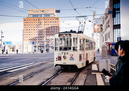 DEC 2, 2018 Hakodate, JAPAN - Hakodate city tram vintage streetcar approaching station near JR train station. The Tram well-established network throug Stock Photo