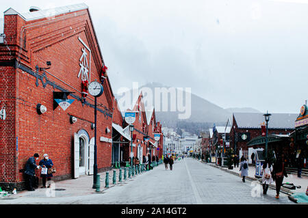 DEC 1, 2018 Hakkodate, Japan -  Hakkodate Red brick warehouses Kanemori at Hakodate port shopping street in winter season foggy atmosphere Stock Photo