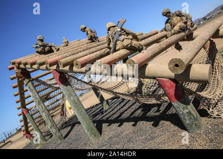 Military recruits navigate through an obstacle course at Camp Pendleton, California. Stock Photo