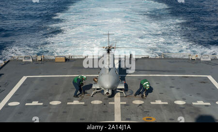 Sailors prepare an MQ-8B Fire Scout unmanned aircraft system. Stock Photo