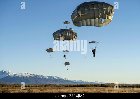 U.S. Army Soldiers descend through the sky over Alaska. Stock Photo