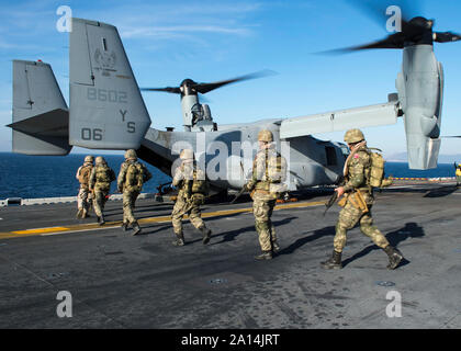 Turkish Marines board an MV-22 Osprey on the flight deck of USS Kearsarge. Stock Photo