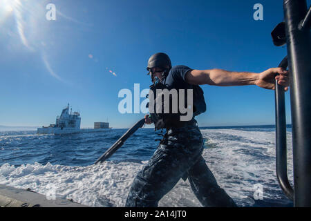 Visit, board, search, and seizure team member prepares to board a vessel. Stock Photo