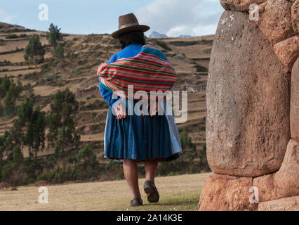Chincheros, Peru - July 31 2011: A typical woman coya walking to her village. Stock Photo
