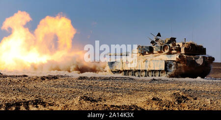 An M1A1 Abrams Main Battle Tank fires its 120 mm smoothbore cannon. Stock Photo