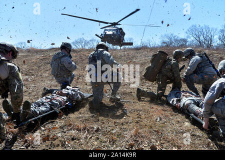 An HH-60 Pavehawk lands to pick up wounded airmen. Stock Photo
