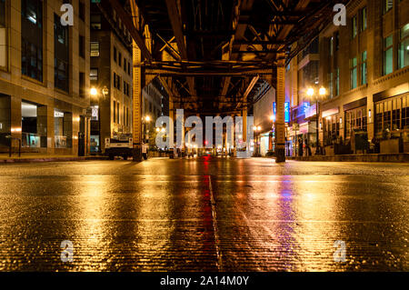 Underneath the elevated train tracks at Wells Street in the Chicago Loop at night. Stock Photo