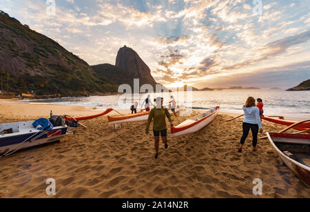 Rio de Janeiro, Brazil - August 17 2013: Group of women preparing outrigger canoes to go to the sea. Photo taken in Red beach, next to the sugarloaf m Stock Photo