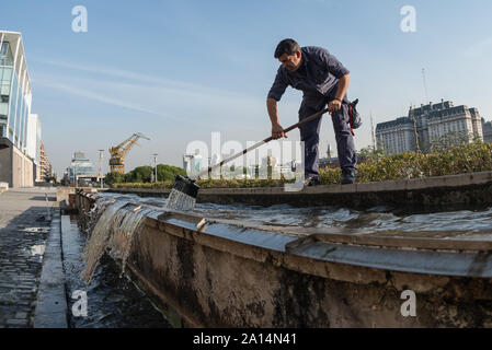 Buenos Aires, Argentina - May 4 2016: A man working and cleaning public spaces in Buenos Aires. Stock Photo