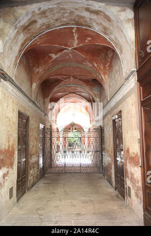 Passage under the circular vault between houses of old construction and the doors of apartments. Stock Photo