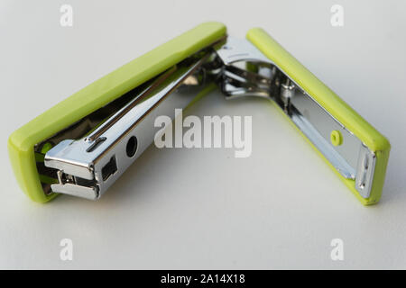 Green stapler isolated on white background. Stock Photo