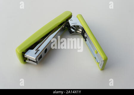 Green stapler isolated on white background. Stock Photo