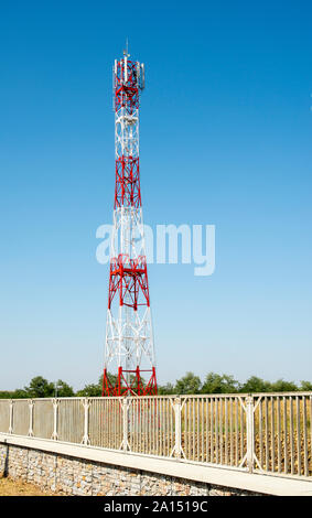 5G antenna for high speed internet distribution. 5G repeaters outside the city. Bright colours red and white. Stock Photo