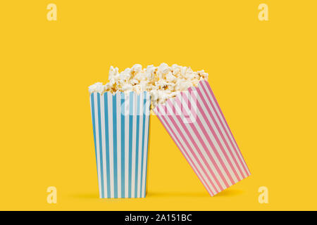 Popcorn in buckets on a yellow background Stock Photo