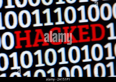Red inscription HACKED in binary code of ones and zeros. Cyber attack electronic devices Stock Photo