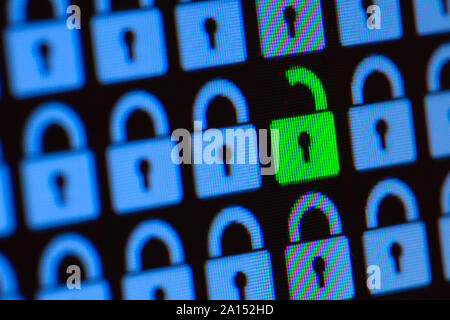 Open padlock as a symbol of the loss of personal information. Hacking or open data. Blue and green pixel locks on a black background, close up. Stock Photo