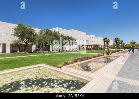 People at the Olive Tree Garden at the Centro Cultural de Belem (Belem Cultural Center) building in Belem district in Lisbon, Portugal, on a sunny day Stock Photo