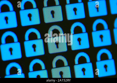 Padlock as a symbol of closed personal information. Internet security storage and transmission of data. Blue pixel locks on a black background, close up. Stock Photo